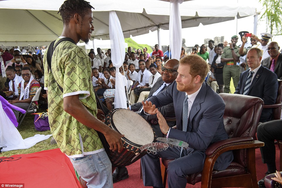 Prince Harry plays the conga drum at Brimestone Hill