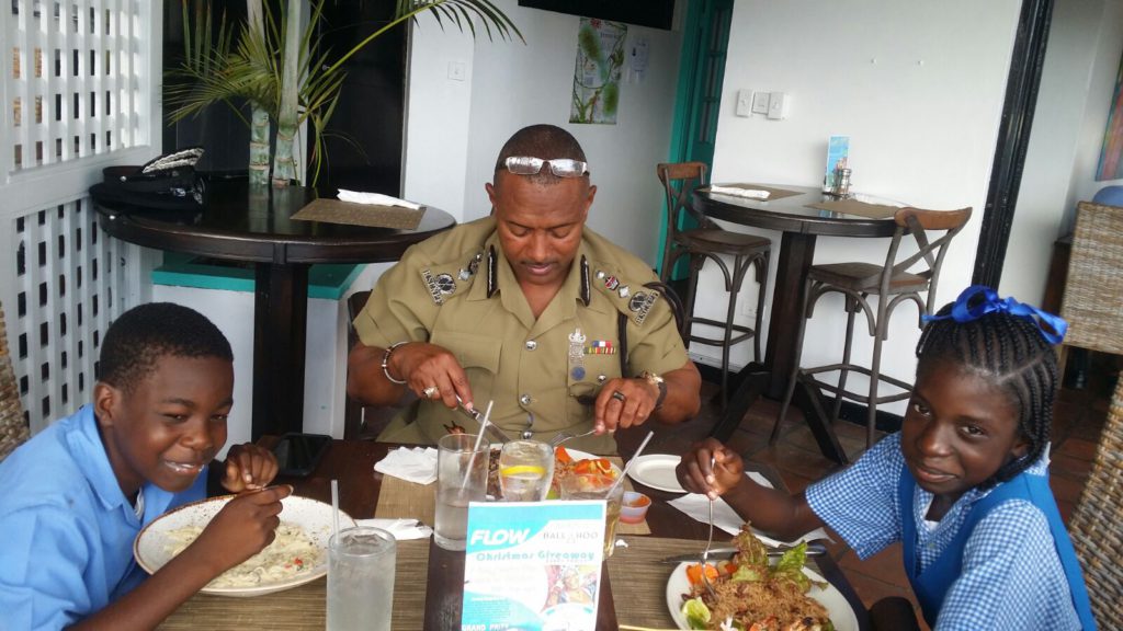 Top Students from Saddlers Secondary Primary School Curmal Stevens and Tei Naaki Davis joins Commissioner Queely for lunch