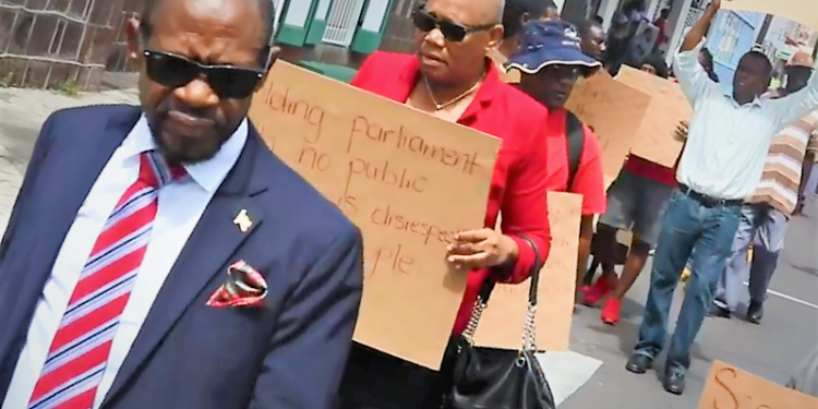 AS HISTORIC TENURE OF OFFICE OF PRIME MINISTER BILL TABLED, LEADER OF ST. KITTS-NEVIS OPPOSITION LEADS PROTEST OUTSIDE PARLIAMENT