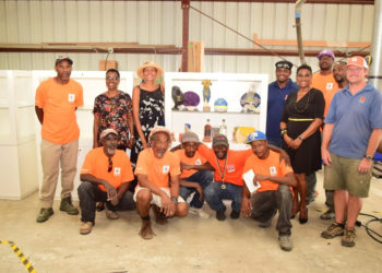 PS CARLENE HENRY-MORTON (2ND FROM RIGHT) AND MINISTRY OFFICIALS POSE WITH RAZO CONSTRUCTION WORKERS