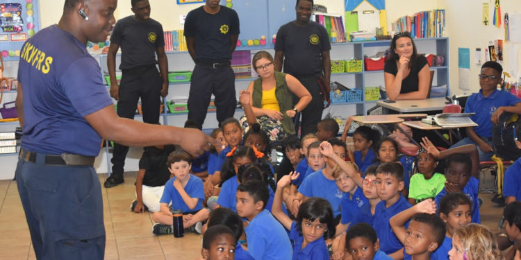 FIRE OFFICERS TEACH CHILDREN ABOUT FIRE SAFETY