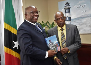 SIR KENNEDY SIMMONDS PRESENTS AUTOGRAPHED COPY OF HIS AUTOBIOGRAPHY TO PRIME MINISTER HARRIS