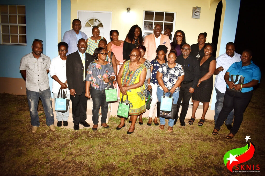 Back Row - Minister Hamilton (Left) and Prime Minister, Dr. the Honourable Timothy Harris (3rd right) along with NHC officials and new homeowners.