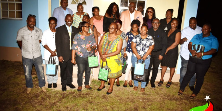 Back Row - Minister Hamilton (Left) and Prime Minister, Dr. the Honourable Timothy Harris (3rd right) along with NHC officials and new homeowners.