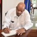 GOVERNOR GENERAL SIGNS BOOK OF CONDOLENCE FOR THE LATE RICHARD CAINES, CSM, JP